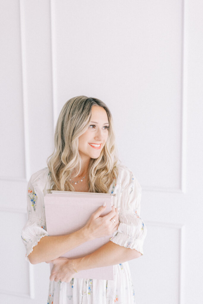 Nichole Pach holding an heirloom album in her Mesa Arizona studio.