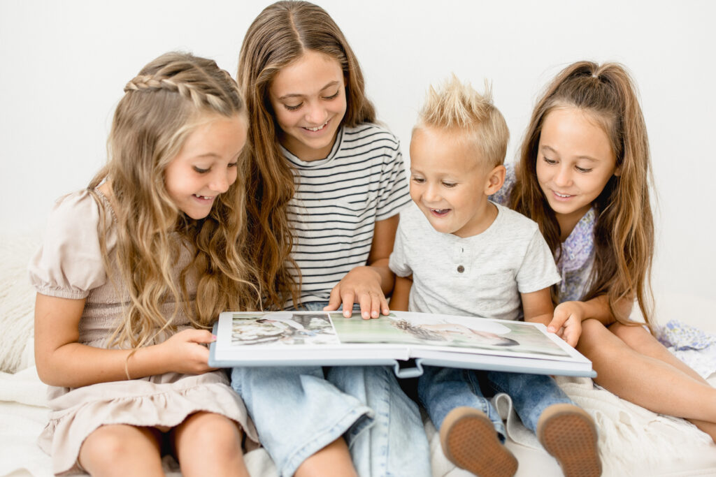 4 young children looking an an heirloom album in Phoenix Arizona