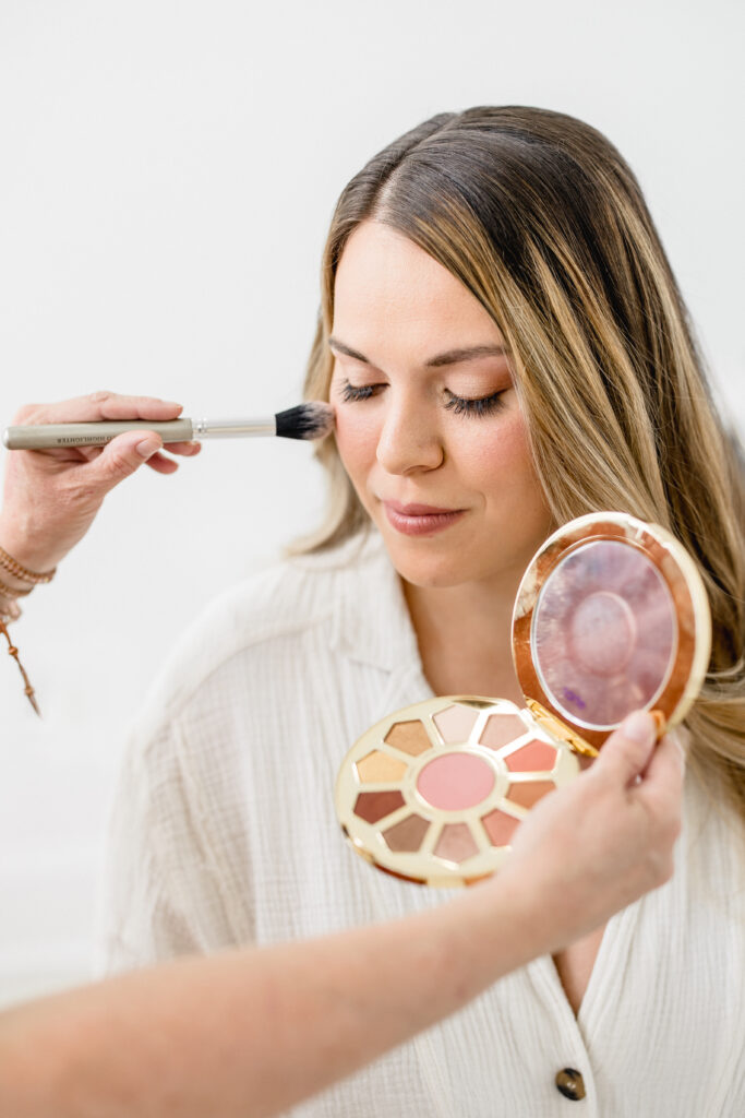 mom getting her makeup done to prepare for her newborn session in Gilbert Arizona
