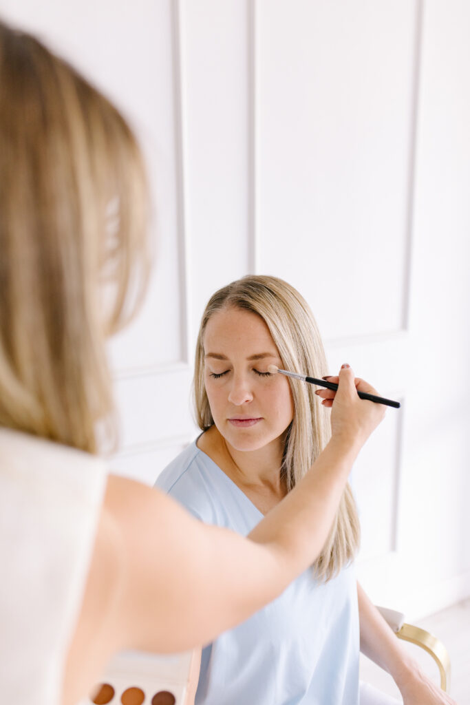 A mom getting her makeup done in white Mesa Arizona studio.